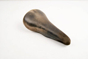 Brown Cinelli Unicanitor leather covered saddle in black from the 70s - 80s